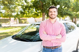 man leaning on car smiling at camera