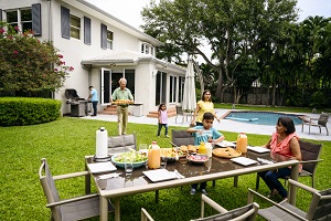 family gathered around table outside for dinner