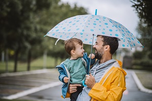 father and son under umbrella