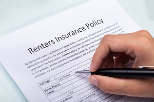 Person Filling Renters Insurance Policy Form